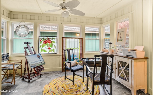 sunroom featuring ceiling fan