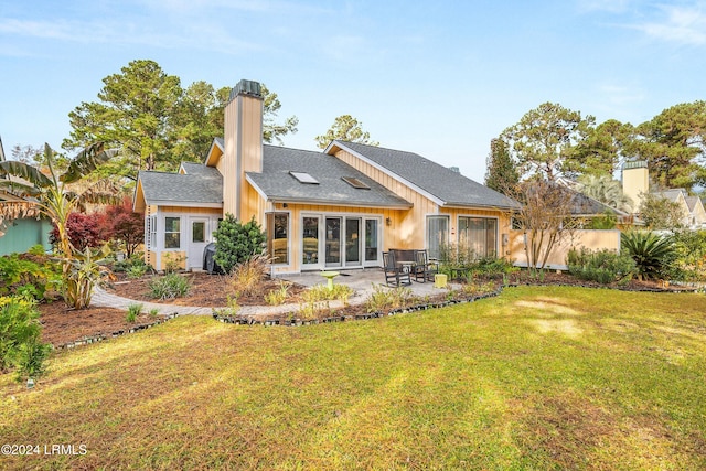 back of property featuring a lawn and a patio area