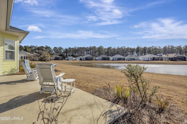 view of yard featuring a water view and a patio area