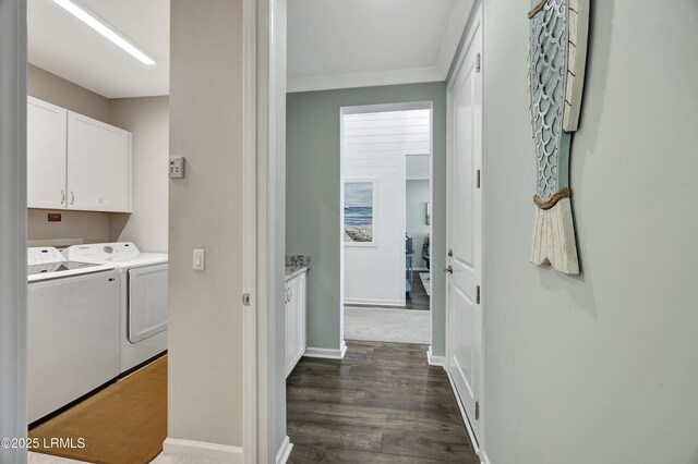 laundry room featuring cabinets, dark hardwood / wood-style flooring, crown molding, and independent washer and dryer