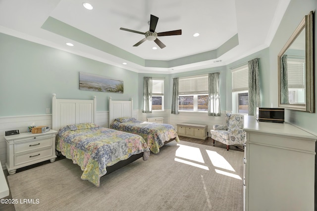 bedroom featuring ceiling fan and a tray ceiling