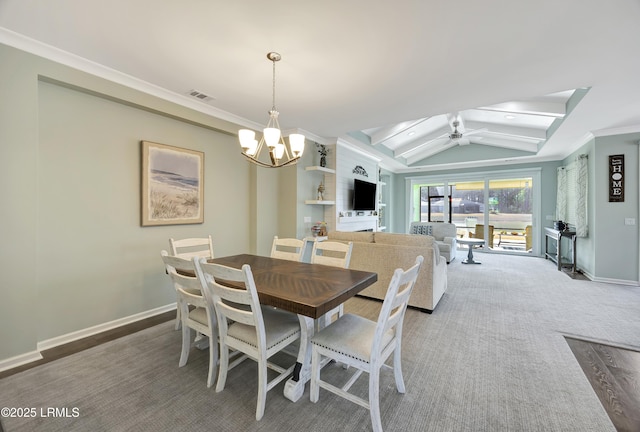 dining space with vaulted ceiling, ceiling fan with notable chandelier, and crown molding