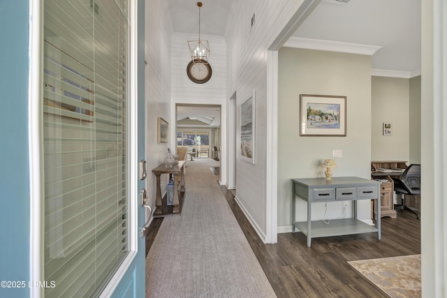 corridor with dark hardwood / wood-style flooring and crown molding