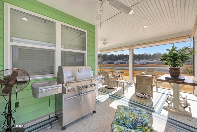 view of patio / terrace featuring a grill, ceiling fan, and exterior kitchen