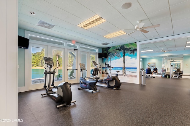 exercise room with a wealth of natural light, a paneled ceiling, and ceiling fan