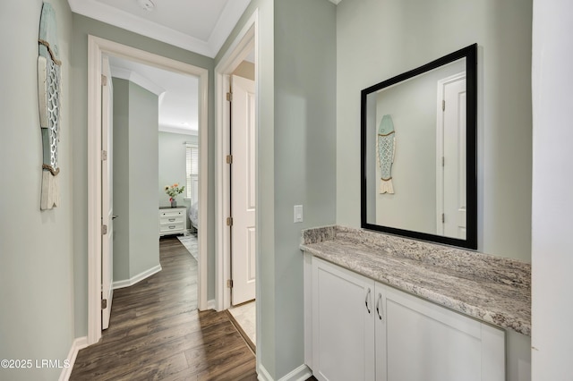 corridor featuring ornamental molding and dark hardwood / wood-style floors