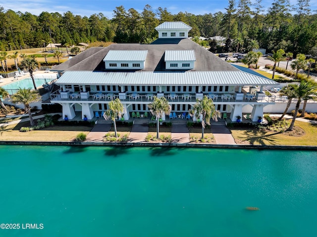 view of swimming pool featuring a water view