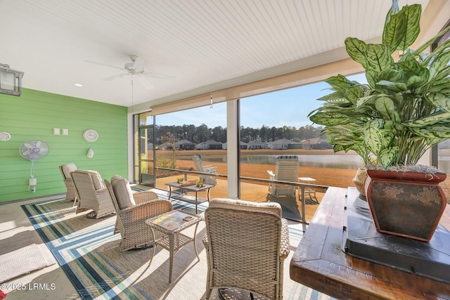 sunroom / solarium featuring ceiling fan