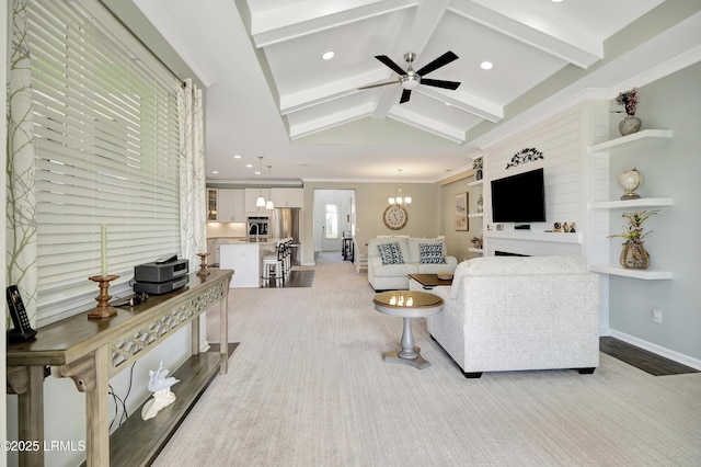 living room with sink, ceiling fan with notable chandelier, and lofted ceiling with beams