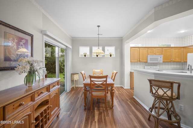 355 Hampton Pl, Bluffton, SC 29909 - dining space featuring dark wood-style flooring, baseboards, crown molding, and a chandelier