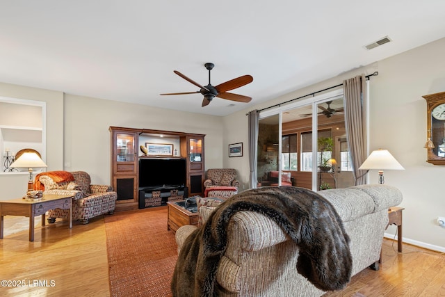 living room featuring ceiling fan and light wood-type flooring