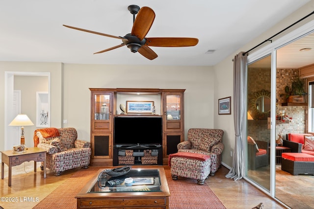 living room with light hardwood / wood-style flooring and ceiling fan