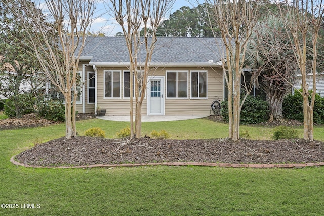 rear view of house featuring a yard and a patio