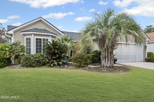 view of side of home featuring a garage and a lawn