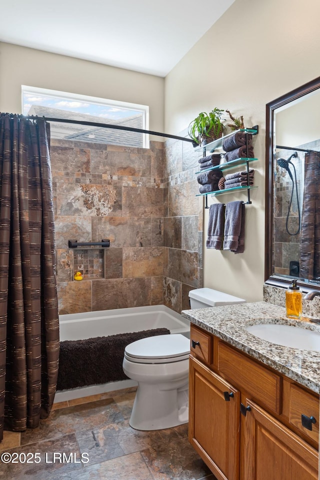 full bathroom with vanity, shower / tub combo, and toilet