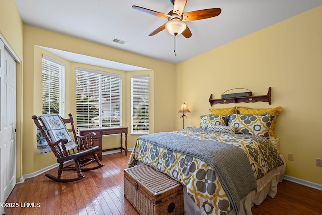 bedroom featuring hardwood / wood-style flooring, ceiling fan, and a closet