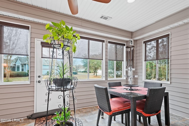 sunroom / solarium featuring ceiling fan