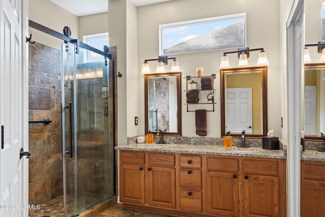 bathroom featuring vanity and a shower with door