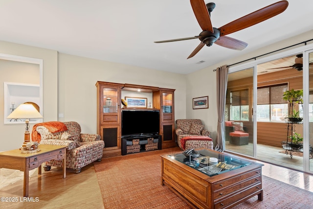 living room with ceiling fan and light wood-type flooring