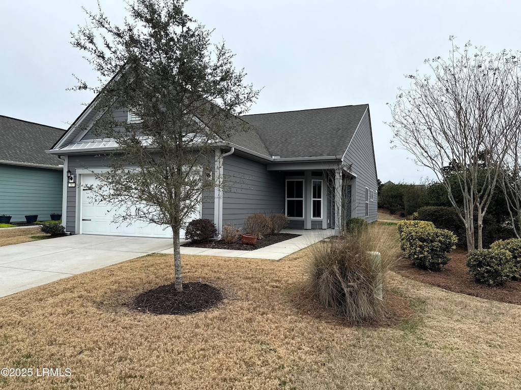 view of front facade with a front yard and a garage