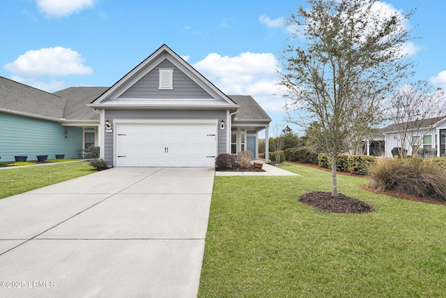 view of front of home featuring a garage, driveway, and a front lawn