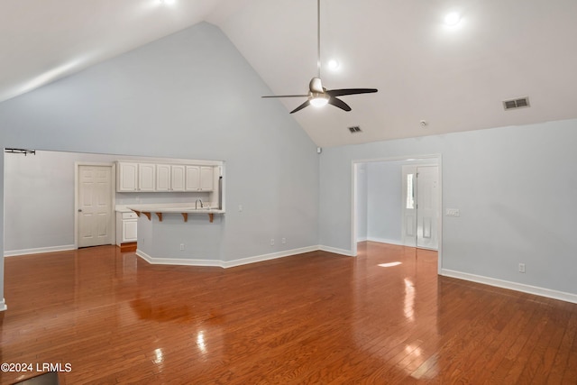 unfurnished living room with wood-type flooring, high vaulted ceiling, and ceiling fan