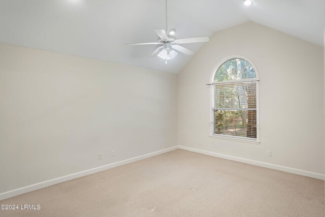 carpeted empty room with ceiling fan and vaulted ceiling