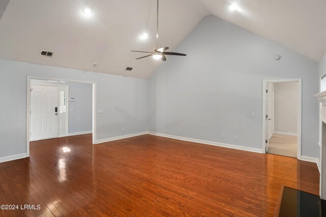 unfurnished living room featuring high vaulted ceiling, dark hardwood / wood-style floors, and ceiling fan