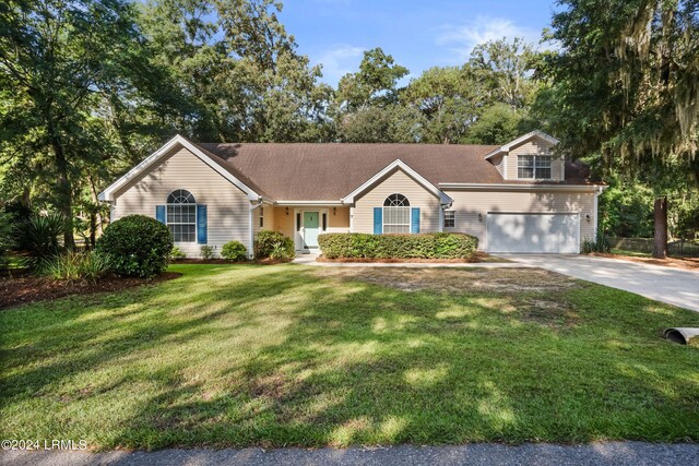 view of front of house featuring a garage and a front lawn