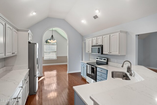 kitchen with sink, white cabinetry, vaulted ceiling, appliances with stainless steel finishes, and dark hardwood / wood-style floors