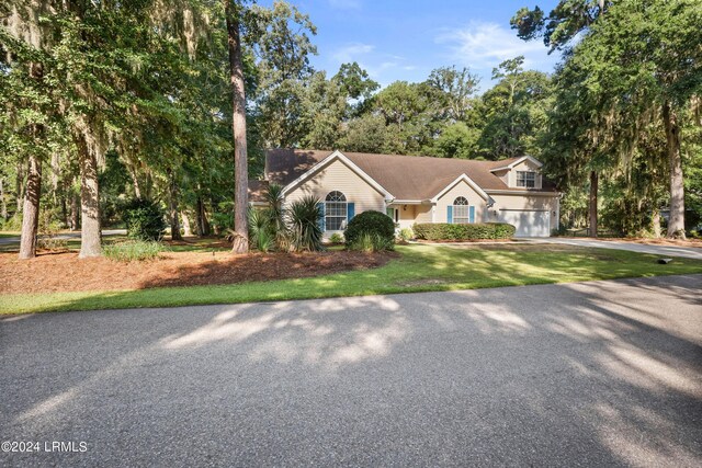 view of front of home with a garage and a front yard