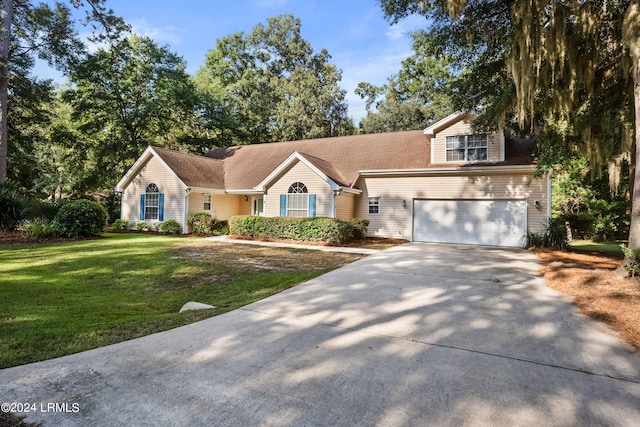 view of front of property with a garage and a front yard