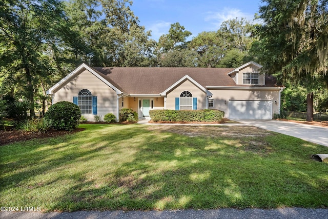 view of front of home featuring a garage and a front lawn