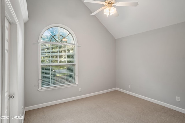 empty room with ceiling fan, carpet floors, and high vaulted ceiling