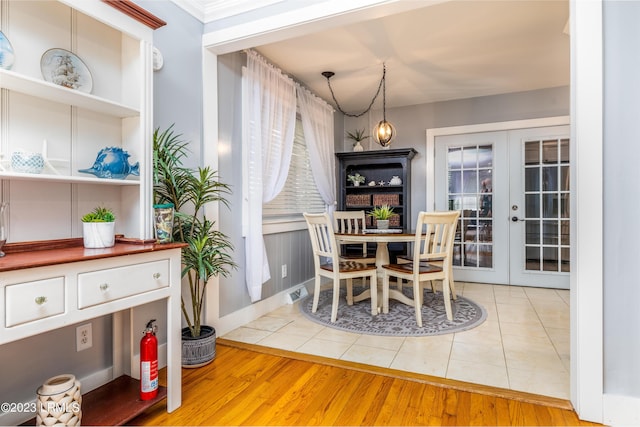 dining room with light tile patterned floors, visible vents, and french doors