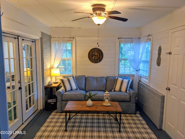 living area featuring french doors and a ceiling fan