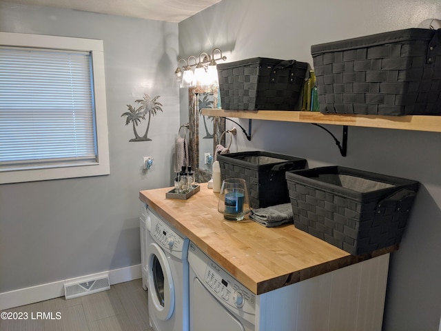 bathroom with visible vents, washer / clothes dryer, and baseboards