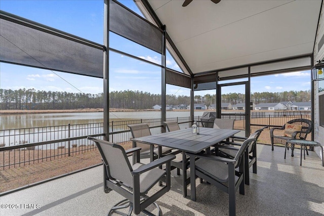 sunroom featuring vaulted ceiling, a water view, and ceiling fan