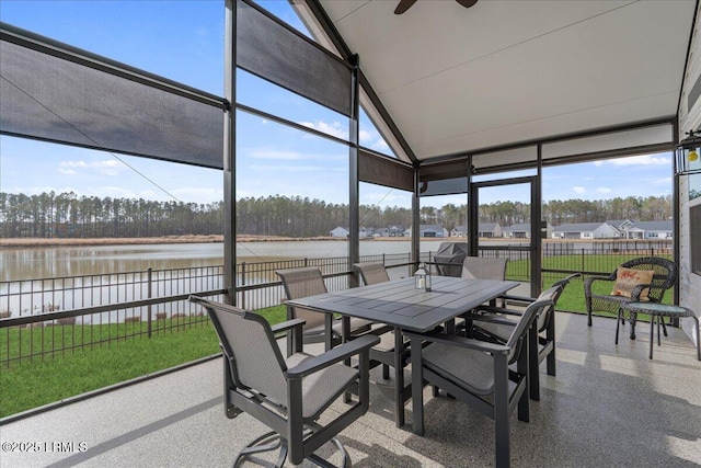 sunroom featuring a water view, plenty of natural light, a ceiling fan, and lofted ceiling