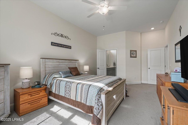 bedroom with light carpet, ensuite bath, ceiling fan, and baseboards