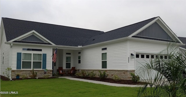 craftsman-style house with a garage and a front lawn