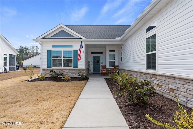 view of exterior entry with a yard