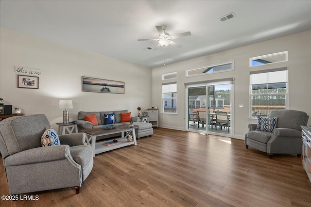 living room featuring hardwood / wood-style floors and ceiling fan