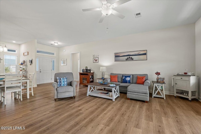 living room with ceiling fan and light hardwood / wood-style floors