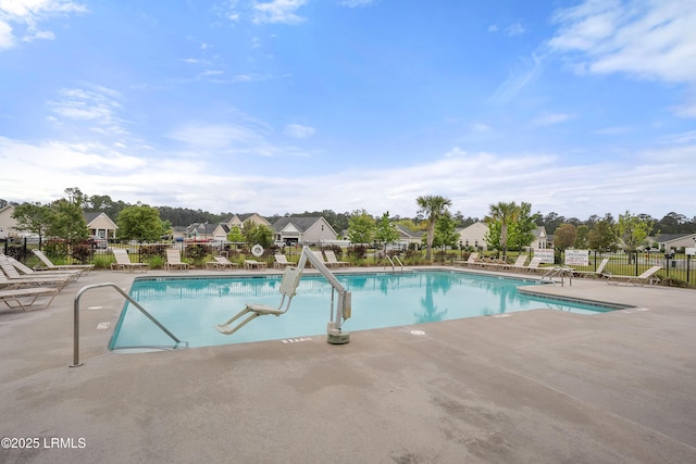 pool featuring a residential view, fence, and a patio