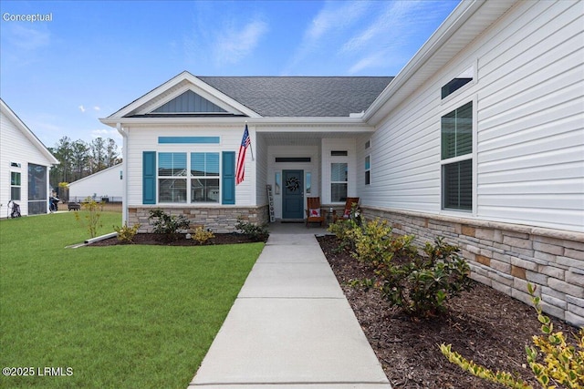 entrance to property with stone siding, a lawn, and board and batten siding