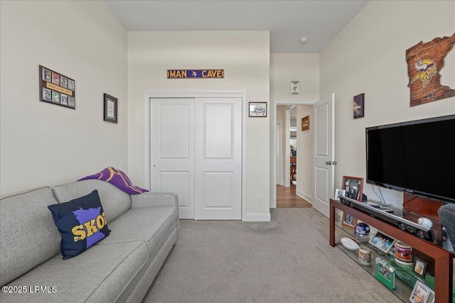 living room featuring light colored carpet and baseboards