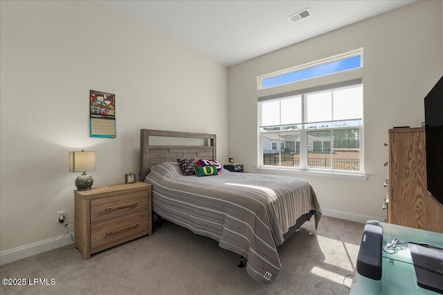 bedroom featuring light carpet, multiple windows, visible vents, and baseboards