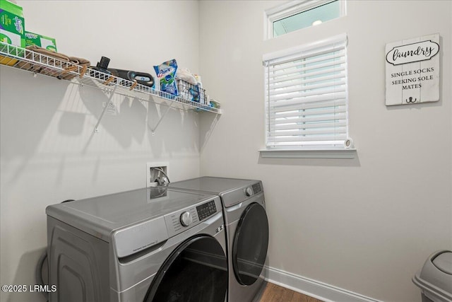 laundry room with washing machine and dryer, a healthy amount of sunlight, and dark wood-type flooring