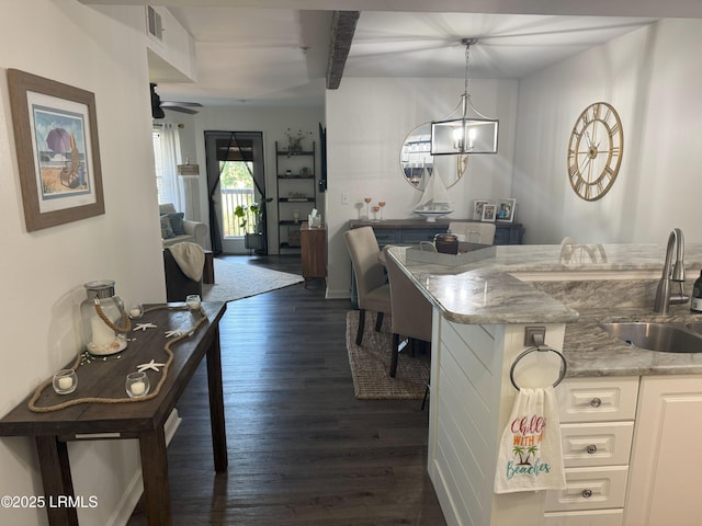 80 Paddle Boat Ln Unit 806, Hilton Head Island, SC 29928 - kitchen featuring dark wood finished floors, ceiling fan, white cabinets, a chandelier, and light stone counters